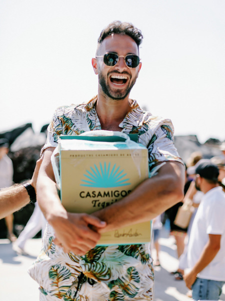 Guest holding welcome gift during Santorini sailing celebration