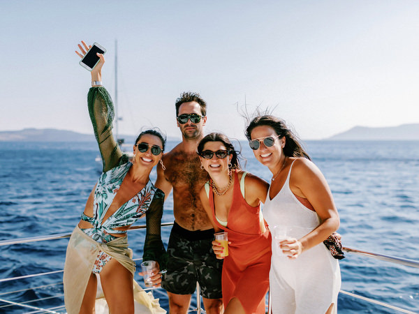 Friends celebrating during Santorini wedding boat trip