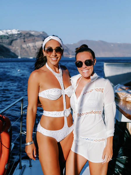 Bride and friend celebrating on Santorini sailing boat