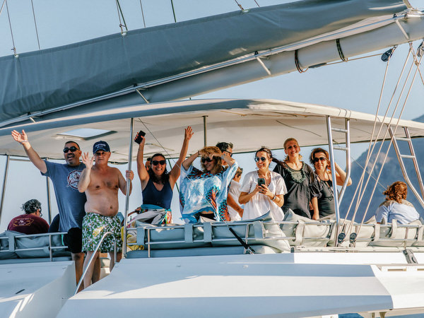 Guests relaxing on deck during Santorini catamaran wedding cruise