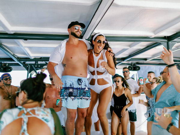 Bride and groom dancing together during Santorini wedding boat party
