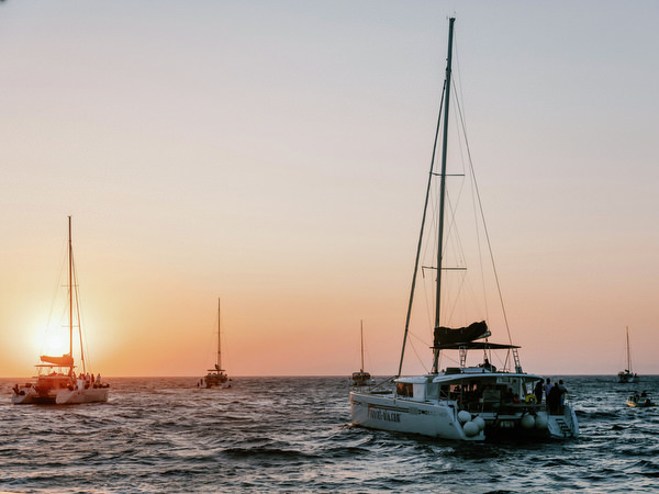 Catamaran silhouette at sunset in Santorini