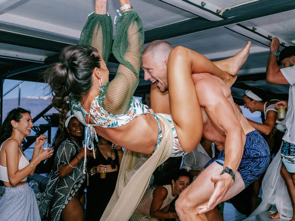 Guests dancing during sunset boat party in Santorini