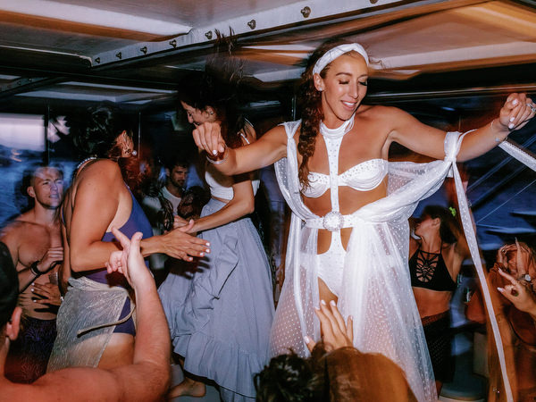 Friends celebrating together during Santorini sunset cruise
