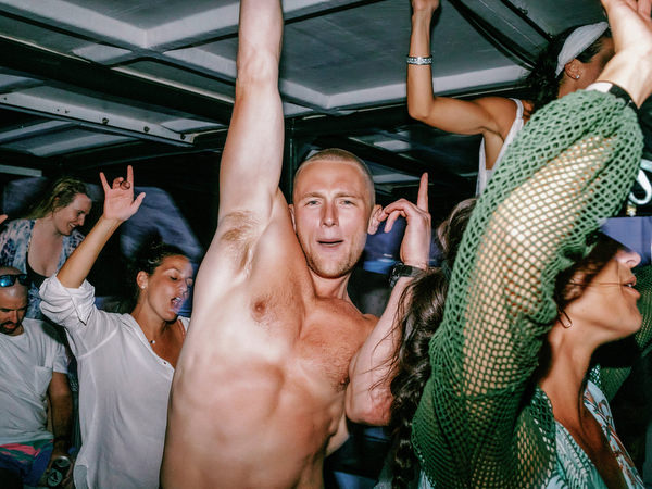Guests celebrating final moments of Santorini wedding cruise
