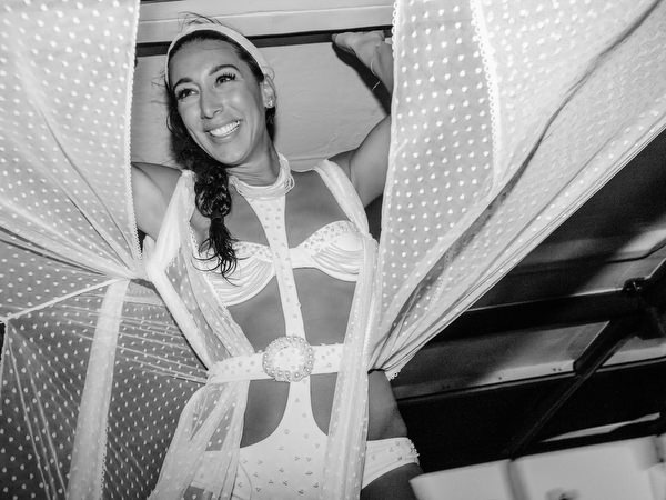 Bride dancing with friends during Santorini sailing celebration