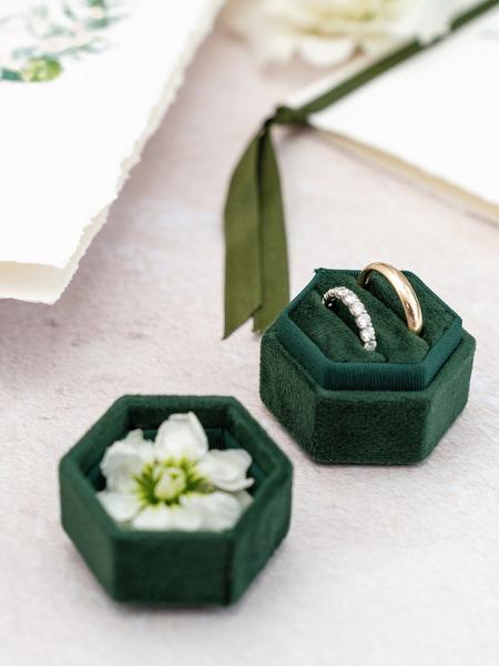 Wedding rings styled in green velvet boxes for Athens luxury wedding.