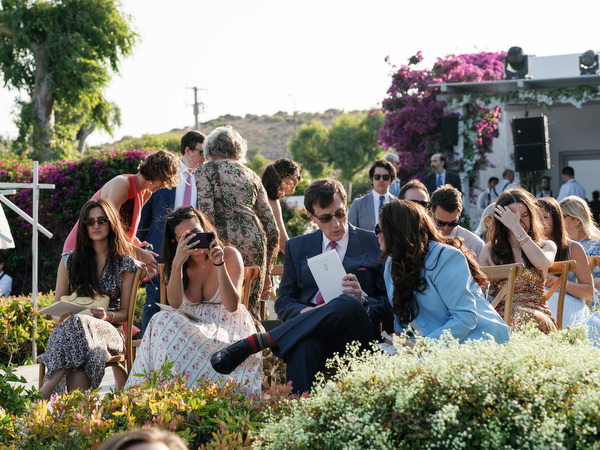 Guests smiling during Island Resort Athens Riviera wedding ceremony.