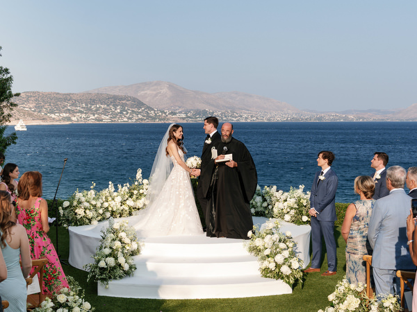 Bride and groom exchanging vows at The Gallery Island Resort Athens Riviera.