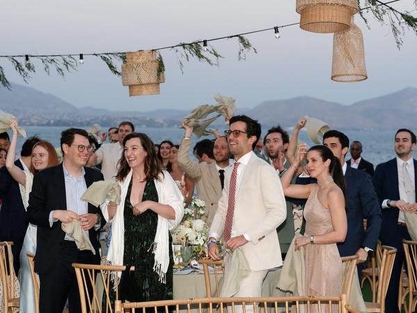 Wedding guests celebrating reception entrance at Island Resort Athens Riviera.