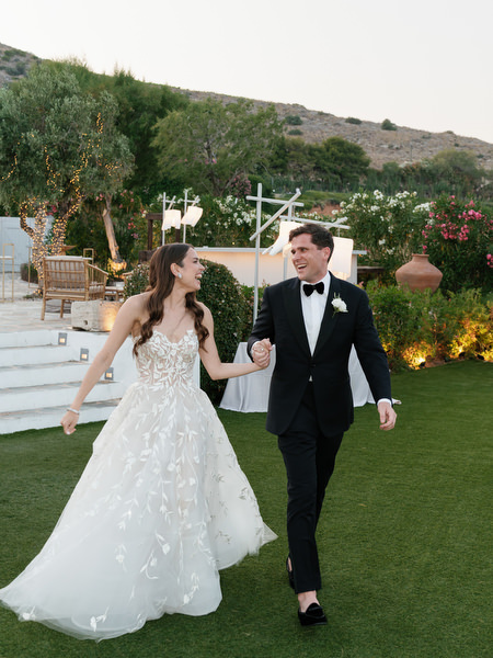 Bride and groom entering reception at The Residence Island Resort Athens Riviera.