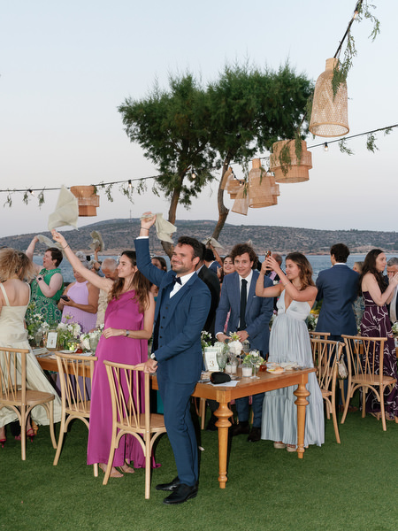 Wedding guests celebrating reception entrance at Island Resort Athens Riviera.