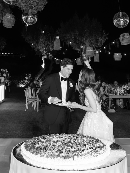 Newlyweds cutting cake at Athens Riviera luxury wedding.