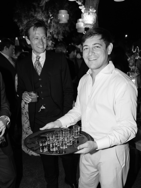 Guests taking shots at Athens Riviera wedding after party.