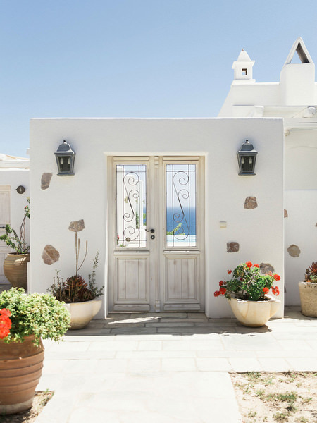 Whitewashed Santorini villa near Venetsanos Winery overlooking the Aegean Sea.