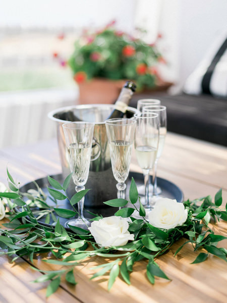 Champagne toast setup at Santorini destination wedding near Venetsanos Winery.
