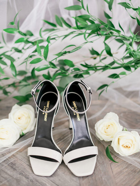 Bridal heels with white roses for luxury Santorini wedding at Venetsanos Winery.