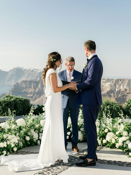 Bride and groom exchanging vows at Venetsanos Winery Santorini.