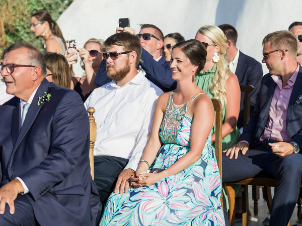 Guests reacting during Santorini winery wedding ceremony.