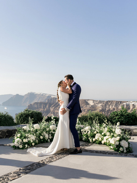 Just married kiss at Venetsanos Winery wedding in Santorini.