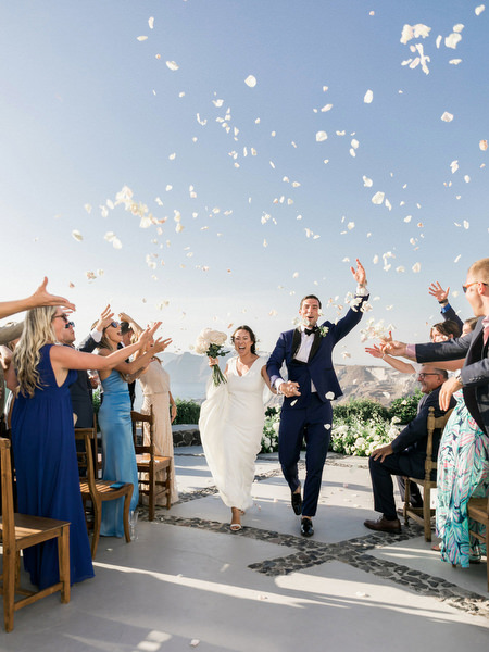 Santorini wedding aisle exit at Venetsanos Winery with petal toss.