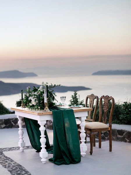 Sweetheart table at Santorini caldera sunset wedding at Venetsanos Winery.