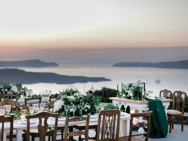 Sunset reception setup at Venetsanos Winery overlooking Santorini caldera.