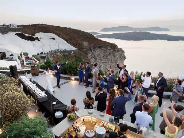 Santorini wedding reception overlooking caldera at Venetsanos Winery.