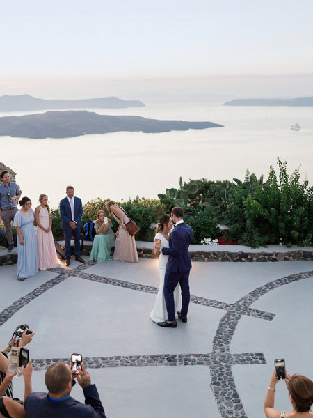 Santorini wedding first dance overlooking caldera at Venetsanos Winery.