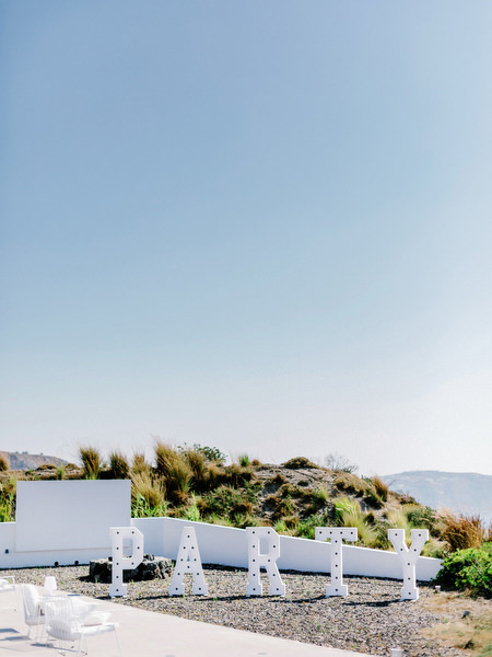Outdoor wedding welcome party decor with sea views in Santorini