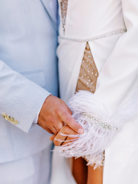 Couple detail on Santorini during destination wedding weekend