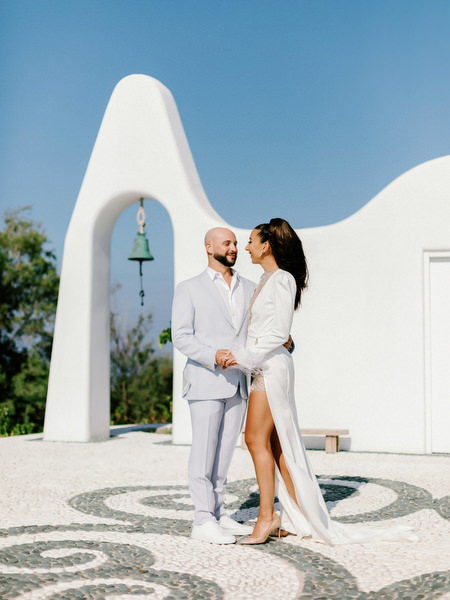 Couple portrait in Santorini chapel courtyard