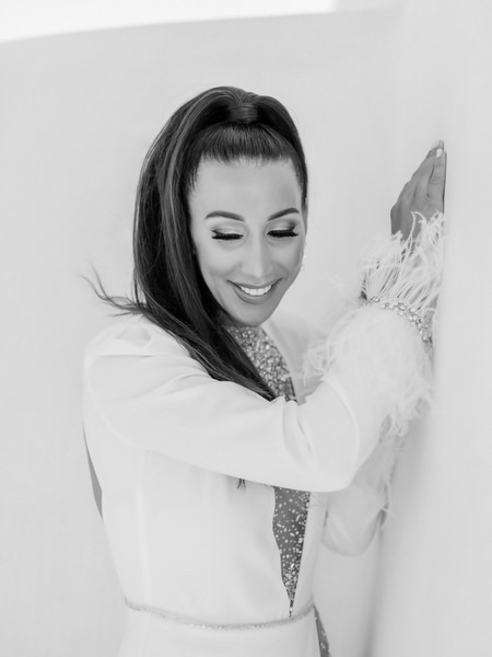 Bride black and white portrait against minimalist white Santorini architecture