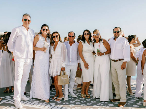 Friends posing together during Santorini wedding celebration