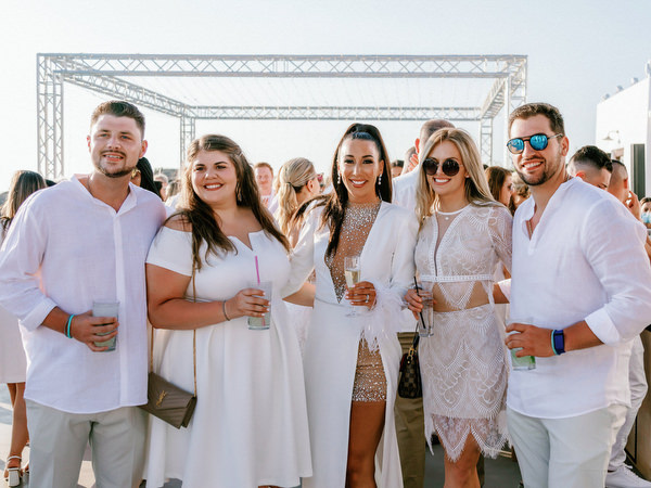 Friends posing together during Santorini wedding celebration