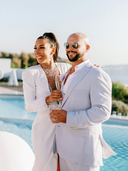 Couple celebrating together at Eros Santorini villa