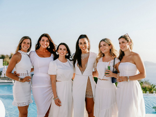 Group of bridesmaids celebrating at Santorini welcome event