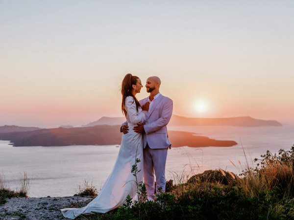 Romantic sunset portrait of couple in Santorini