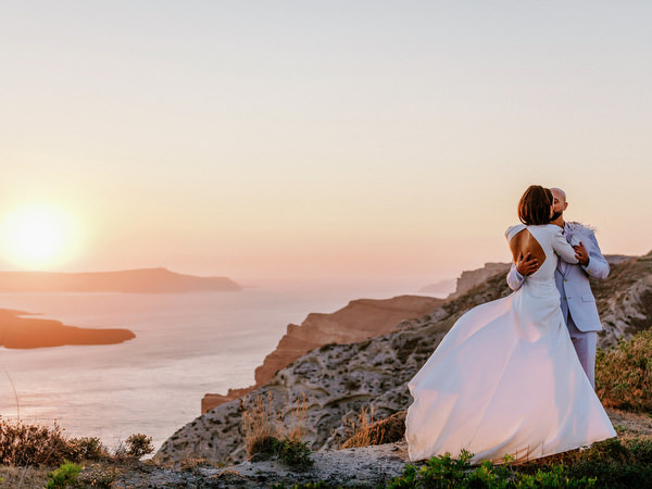Couple kissing at sunset overlooking Aegean Sea