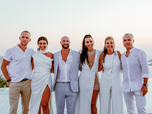 Wedding family enjoying Santorini sunset views