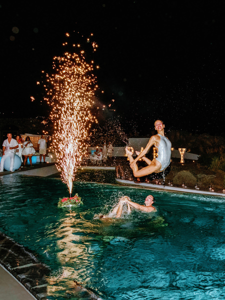 Poolside performance during Santorini wedding welcome celebration