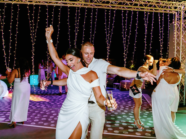 Guests celebrating poolside during Santorini wedding party