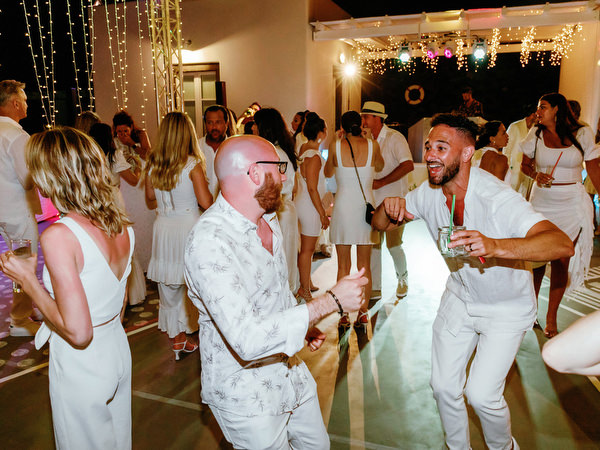 Guests celebrating late night at Eros Santorini villa