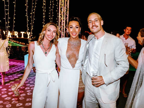 Friends dancing during Santorini destination wedding weekend
