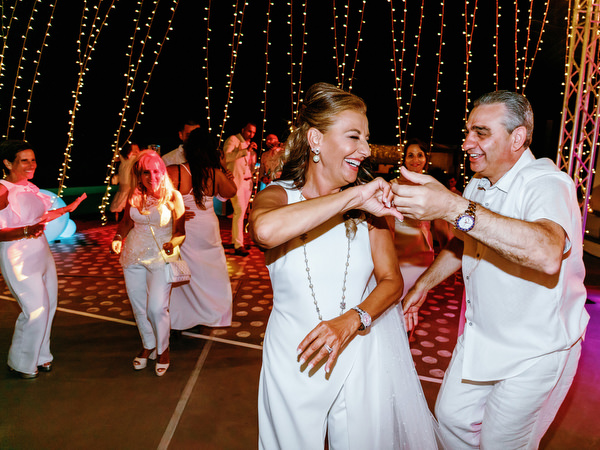 Wedding guests enjoying night party at Santorini welcome celebration