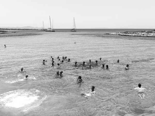 Guests swimming near sailboat during Antiparos pre-wedding boat cruise