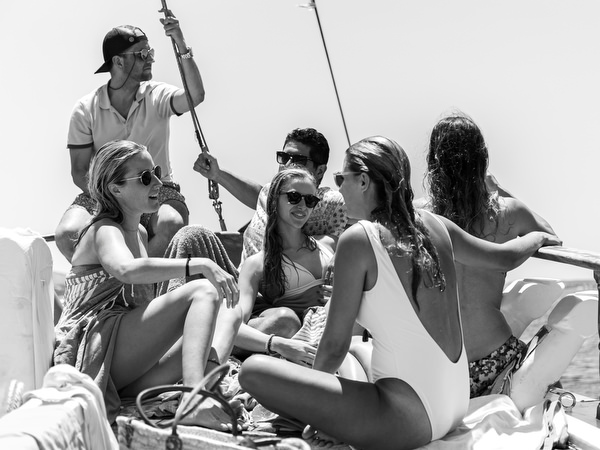 Guests chatting and laughing during Antiparos pre-wedding boat cruise