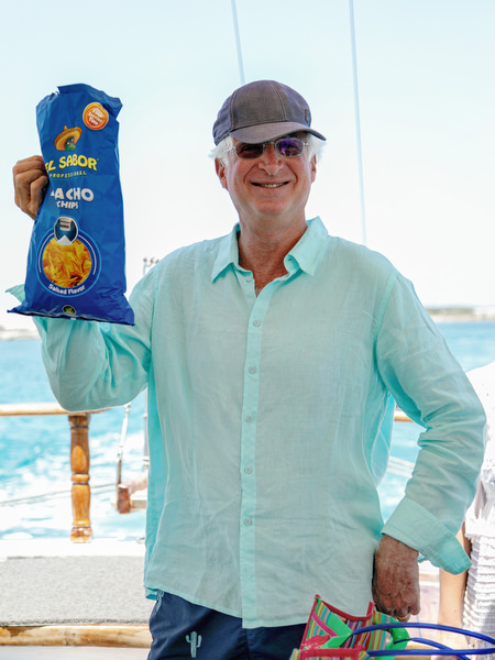 Guest holding nachos during Antiparos pre-wedding boat cruise