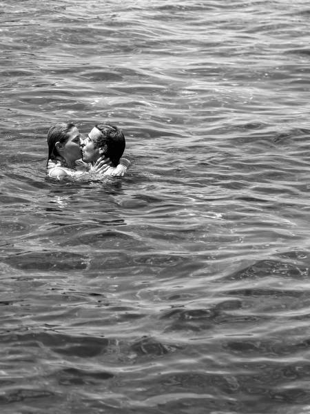 Couple swimming together during Antiparos pre-wedding boat cruise