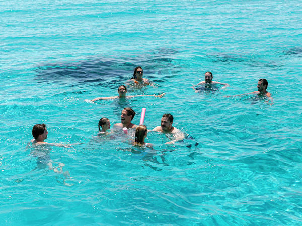 Group swimming in turquoise water during Antiparos pre-wedding cruise